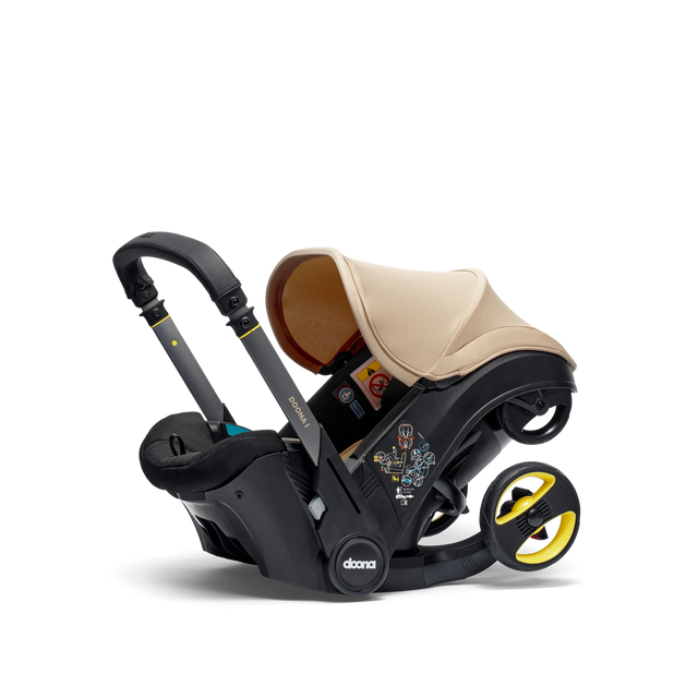 Doona i Babyschale in Sahara Sand mit 2-in-1 Autositz und Kinderwagenfunktion, Sicherheitsgurten und Seitenaufprallschutz